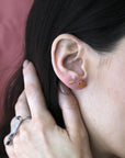 Girl wearing studs earrings and the double finger ring with round diamond statement Bena Jewelry Montreal