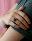 girl wearings a black cocktail ring bena jewelry montreal smoky quartz edgy jewelry unisex color gemstone minimalist black gemstone unisex ring montreal made in little italy jewelry studio