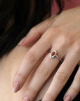 girl wearing a pear shape garnet spessartite diamond halo engagement ring bena jewelry custom color gemstone custom made engagement ring handmade in montreal little italy jewelry studio