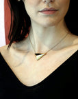 Women with a black shirt wearing vermeil gold pyramidal pendant Edgy Collection Montreal Made in Canada