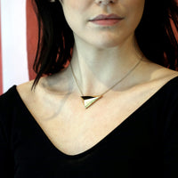 Women with a black shirt wearing vermeil gold pyramidal pendant Edgy Collection Montreal Made in Canada