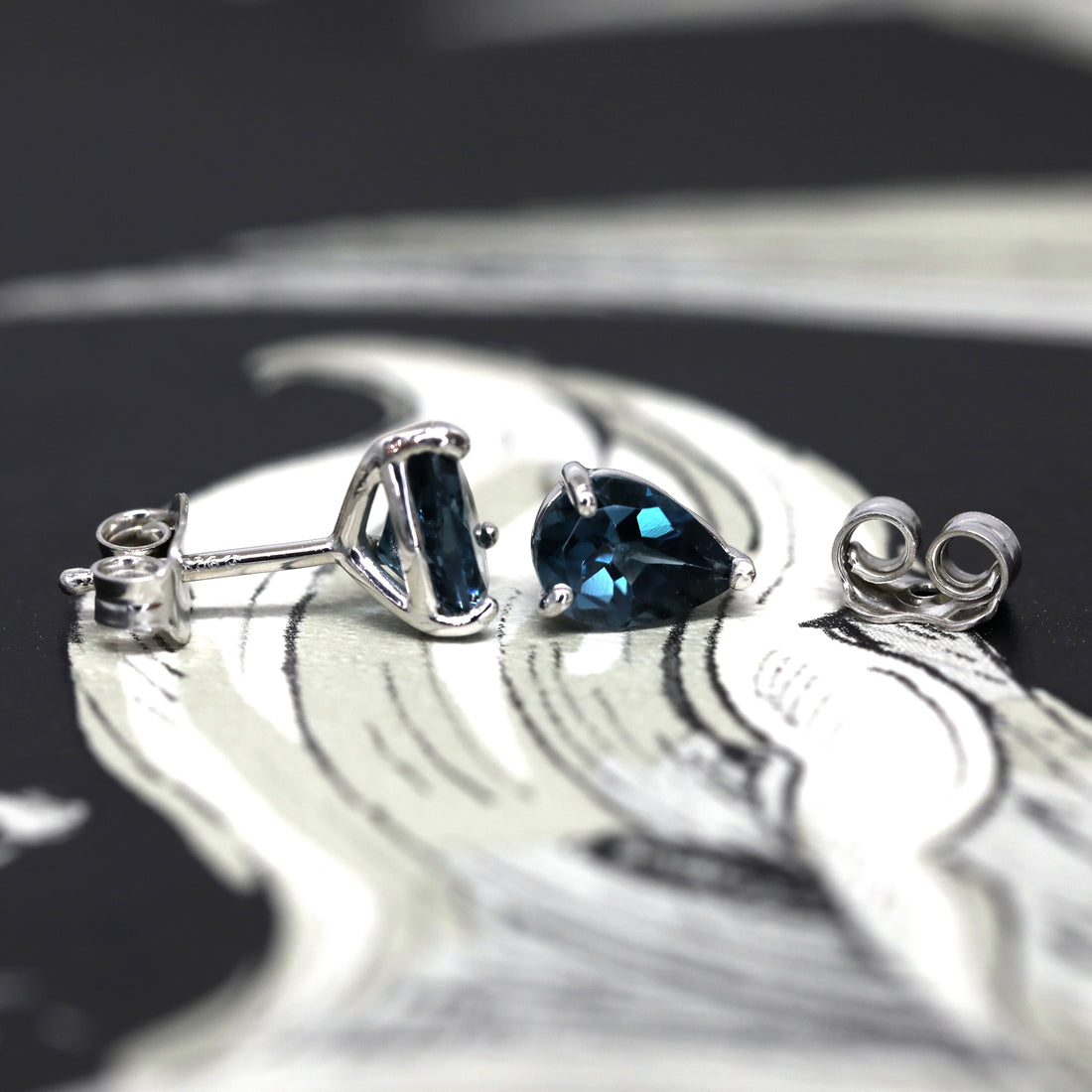 Side view of topaz gemstone stud earrings bena jewelry montreal made in canada custom small color gemstone earrings blue topaz small gems montreal jeweler