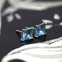 Side view of sky blue topaz jewelry montreal made in canada fine jewelry designer small blue gems earrings stud canada little italy montreal jeweler custom made color gemstone spcialist