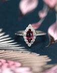 Front view of edgy diamonds ring marquise shape red gemstone garnet precisous fine jewelry white diamonds engagement ring white gold ring bena jewelry montreal made in canada custom fine jewrelry