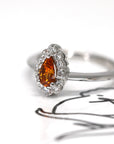 side view of pear shape orange spessartite garnet diamond ring bena jewelry custom made bridal engagement ring color gemstone bridal jewelry specialist montreal handmade in little italy jewelry studio