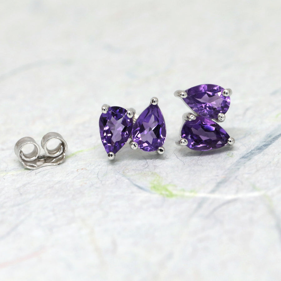 Front view on white background of double pear amethyst gemstone studs earrings made in Montreal by Bena Jewelry Designer