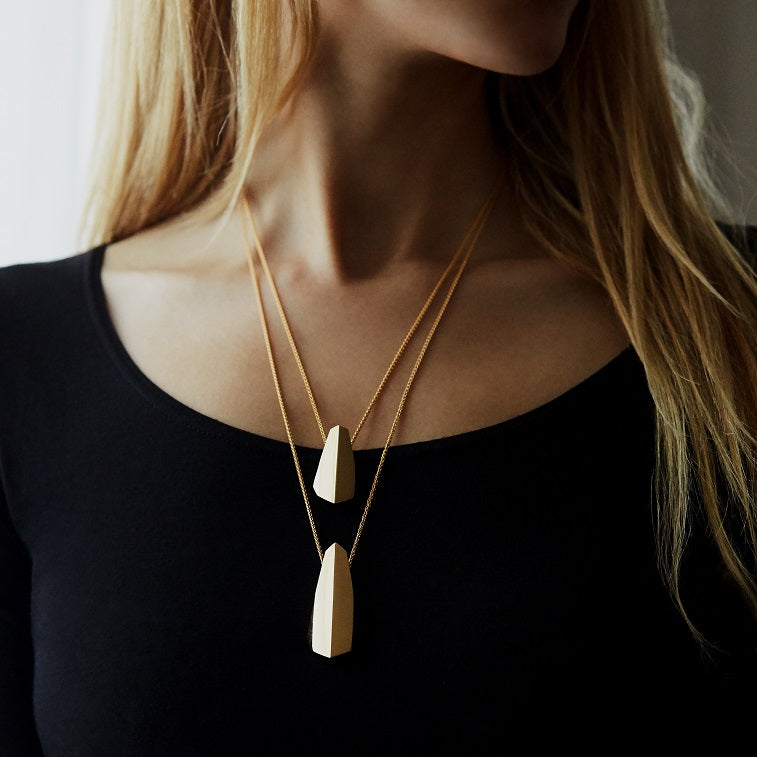 Woman wearing statement gold plated pendant Edgy Collection bena jewelry custom jewelry designer montreal made in canada