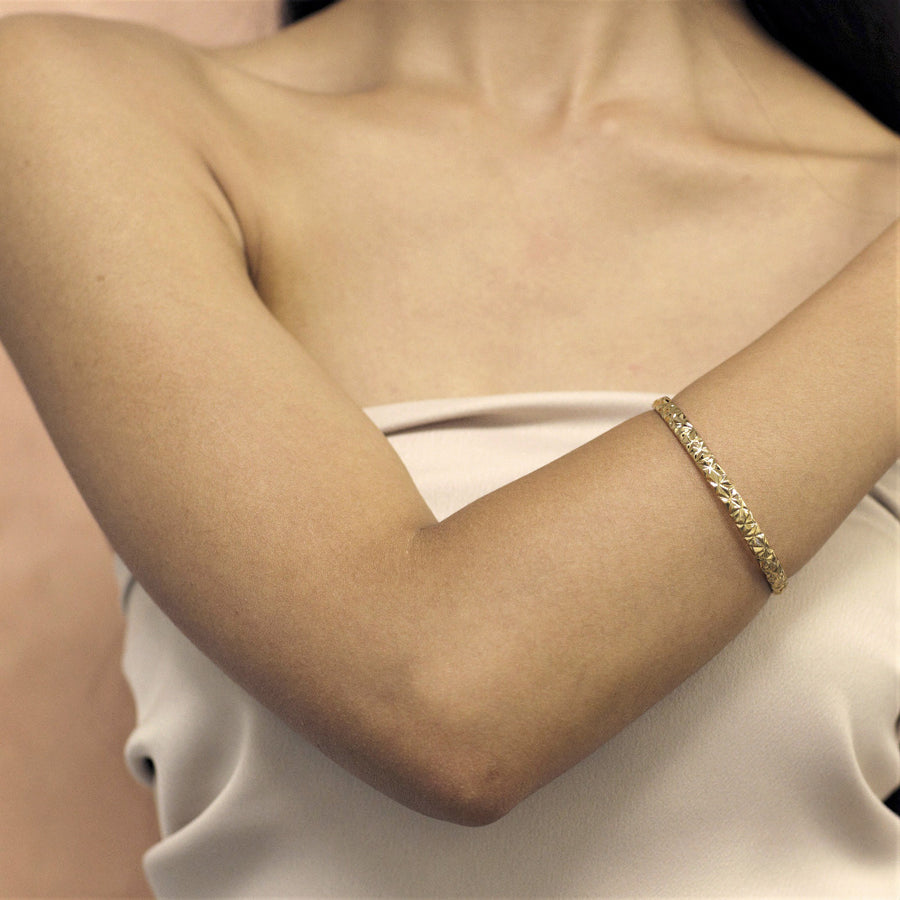 girl wearing gold edgy bangle bracelet bena jewelry designer