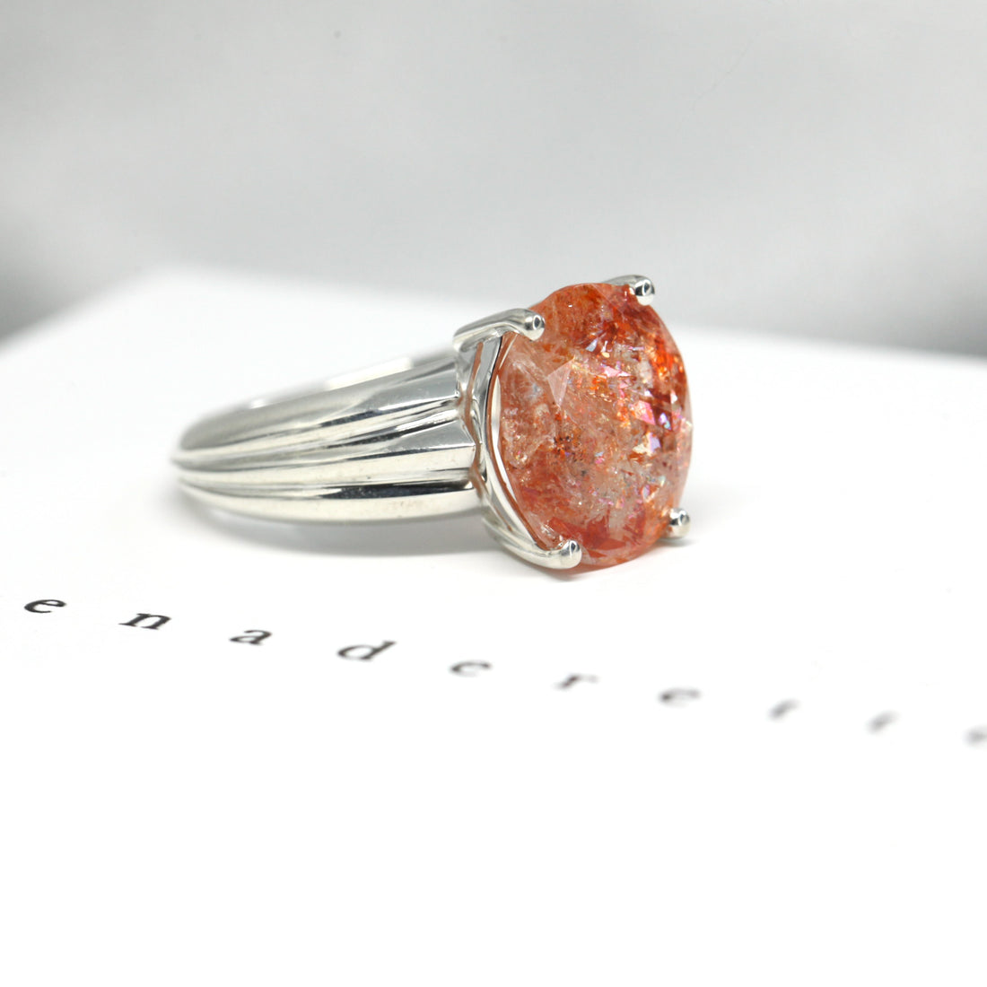 Side view of cocktail ring orange color gemstone custom made silver ring big bold color gems silver fine jewelry glitter hemmatite inclusion gems from india ring design made in montreal handemade in canada