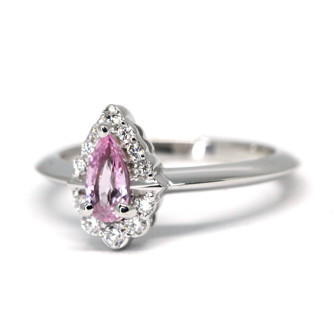 Side view of pink sapphire engagement ring bena jewelry montreal pear shape natural pink gemstone edgy bridal custom made jewelry bridal engagement ring diamond halo made in montreal handmade in canada bena jewelry fine jewelry Montreal Little italy jeweler