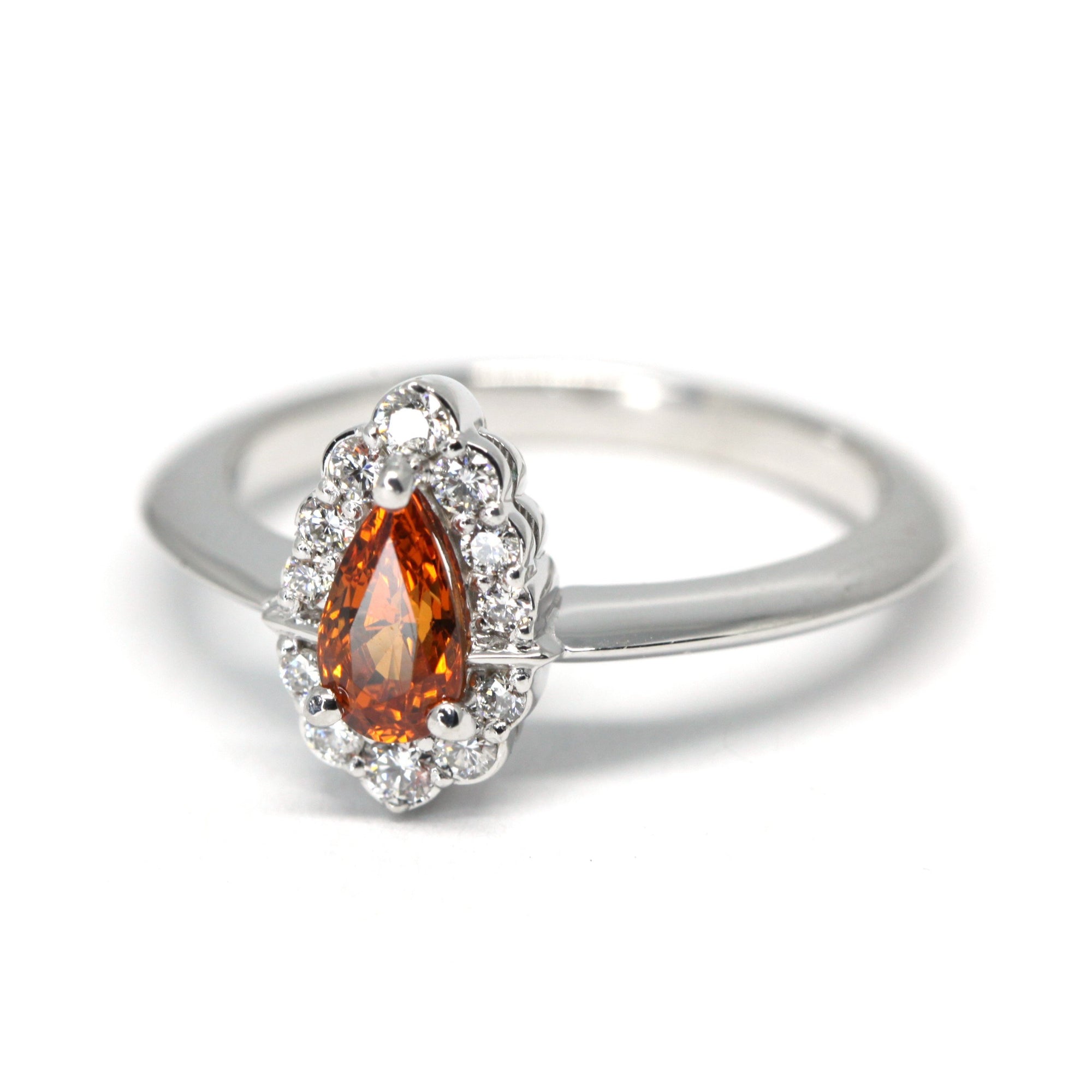 side view of spessartite garnet and diamond halo engagement ring bena jewelry montreal fine jewelry designer pear shape spessarite vivid orange color gemstone bridal ring white gold custom made bridal ring montreal fine jewelry