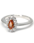 side view of spessartite garnet and diamond halo engagement ring bena jewelry montreal fine jewelry designer pear shape spessarite vivid orange color gemstone bridal ring white gold custom made bridal ring montreal fine jewelry