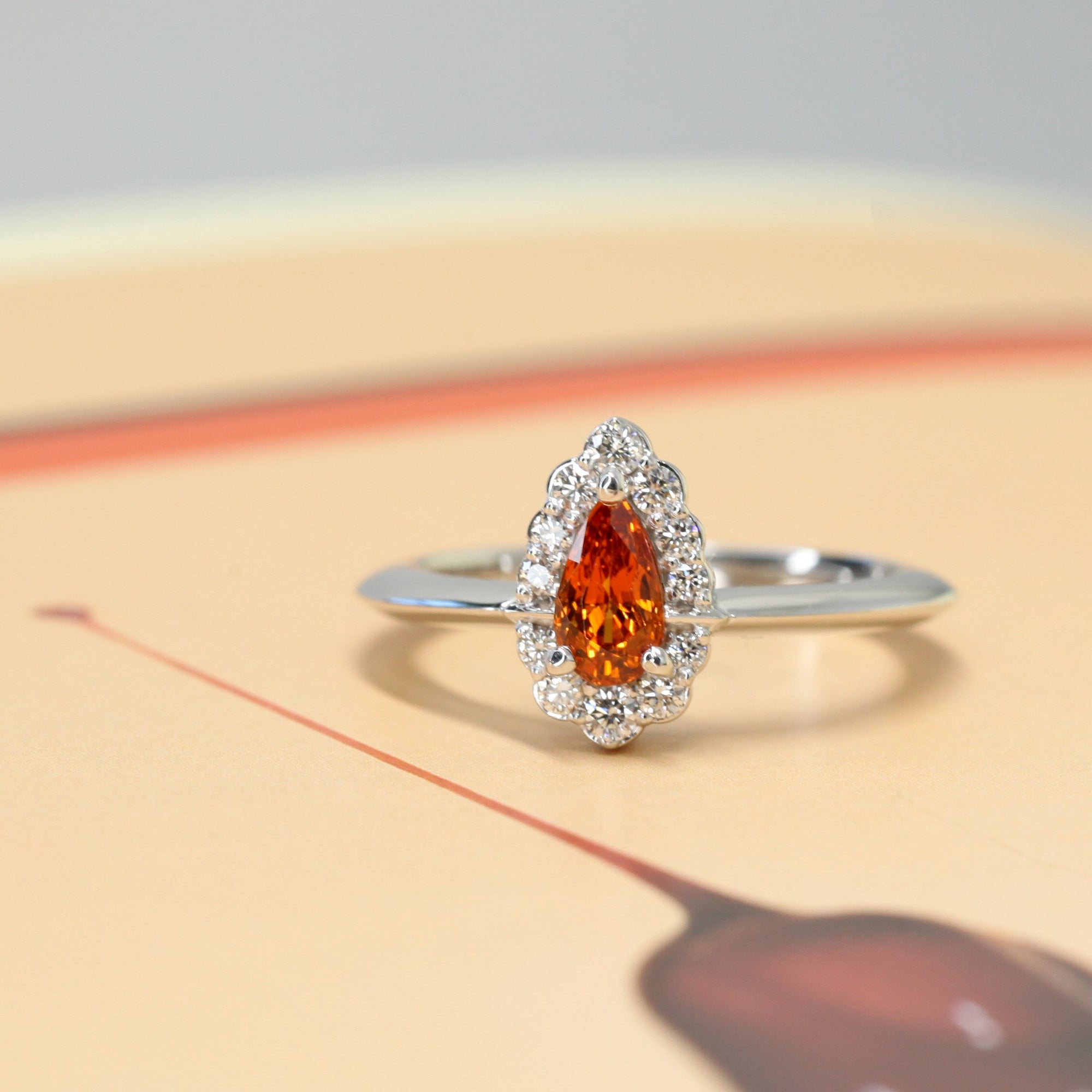 front view of pear shape garnet ring bena jewlery montreal custom color gemstone bridal jewelry handmade in montreal vivid orange engagement ring handmade in montreal little italy jewelry studio fine jewelry