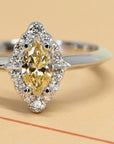 Crop picture of natural color gemstone yellow diamond marquise shape engagement ring whit small round white diaomonds vintage bridal ring GIA certified natural yellow diamond white gold ring