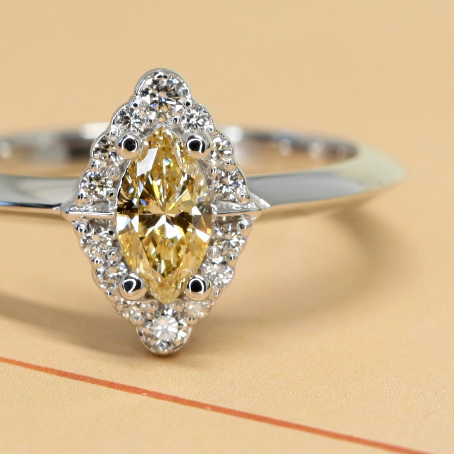 Crop picture of natural color gemstone yellow diamond marquise shape engagement ring whit small round white diaomonds vintage bridal ring GIA certified natural yellow diamond white gold ring