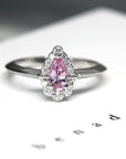 Front view of pear shape pink sapphire white gold diamond engagement ring custom made in montreal fine ethical jewelry studio montreal color gemstone bridal ring specialist pink gemstone bridal ring