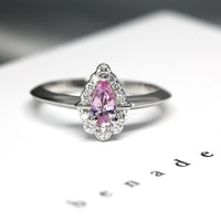 Front view of pear shape pink sapphire white gold diamond engagement ring custom made in montreal fine ethical jewelry studio montreal color gemstone bridal ring specialist pink gemstone bridal ring