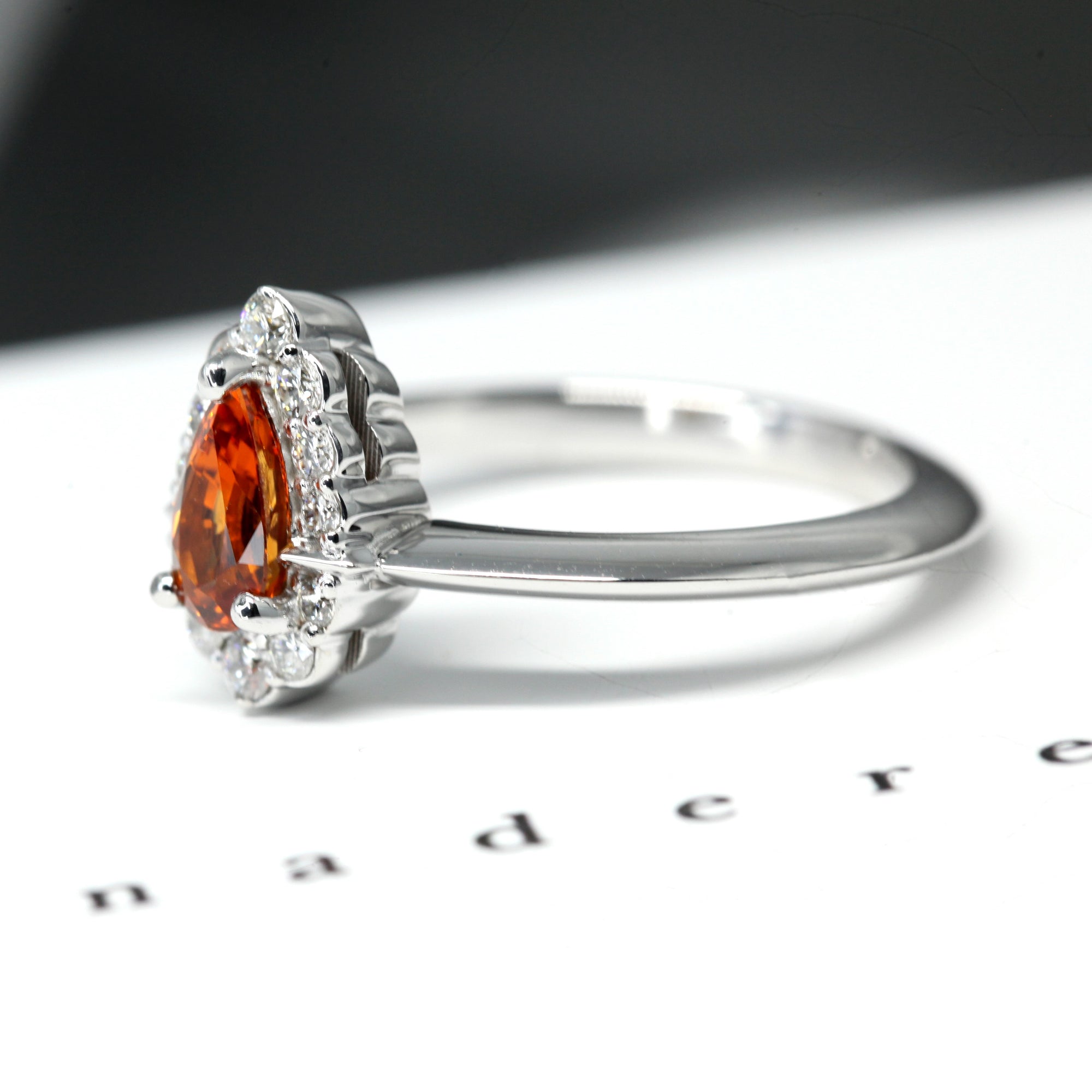 side view of pear shape orange garnet gemstone diamond engagement ring montreal handmade in canada custom made bridal jewelry color gemstone bridal engagement ring garnet spessartite pear shape gold ring