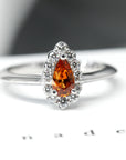 front view of orange garnet spessartite gemstone diamond halo ring white gold bena jewelry color gemstone custom made fine jewelry orange pear shape diamond montreal made in canada fine jewelry color gemstone bridal jewelry design