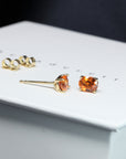 side view of bena jewelry garnet stud earrings made in montreal vivid natural orange gemstone stud earrings bena bridal jewelry montreal made custom made unisex fine jewlery with natural color gemstone montreal made in canada bena jewlelry designer