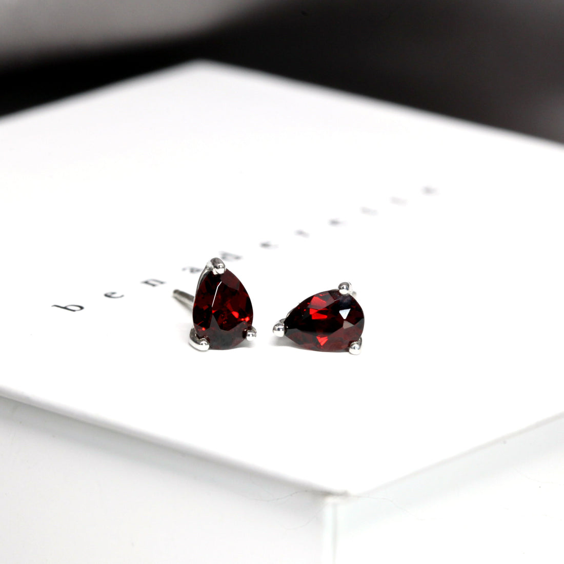 front view of red garnet pear shape studs earrings montreal bena jewelry minimalist custom made color gemstone garnet jewelry small studs pear shape red earrings montreal handmade in canada