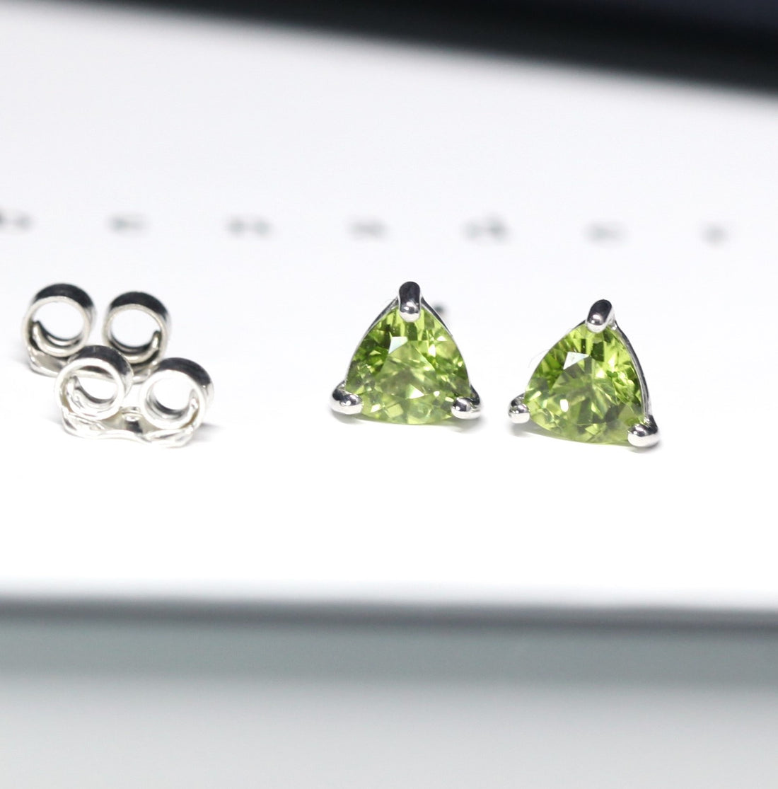 Gemstone stud earrings trillion peridot bena jewelry minimalist gemstone earrings small trillion peridot shape earrings green gemstone stud earrings bena jewelry montreal little italy jewelry studio fine color gemstone jewlery montreal made in canada jewelry designer