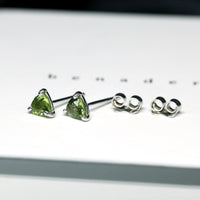 Side view of edgy small Bena Jewelry green sapphire small trilloin shape gemstone studs earrings custom made color gems bridal and everyday minimalist bold unisexe jewelry ethical custom made jewelry design montreal little italy jeweler natural gemstone stud earrings