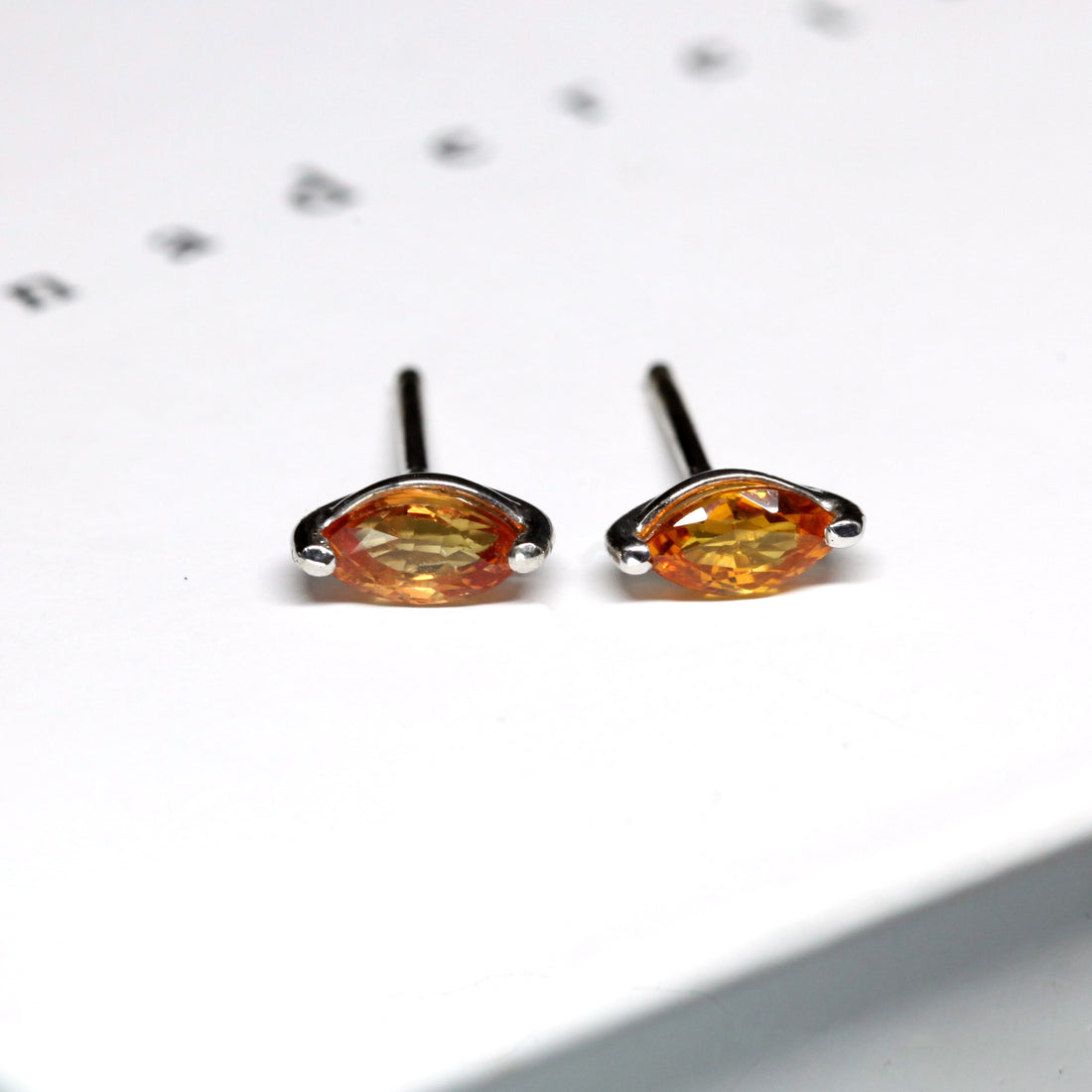 front view of gemstone stud earrings bena jewelry montreal orange gemstone stud earrings custom maed jewelry in montreal handmade in canada minimalist unisex edgy jewelry