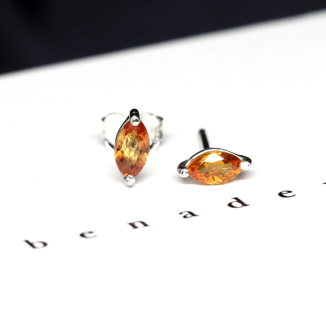 Front view of marquise shape orange sapphire small gemstone stud earrings bena jewelry edgy fine collection natural orange gemstone custom made in montreal canada small marquise sapphire