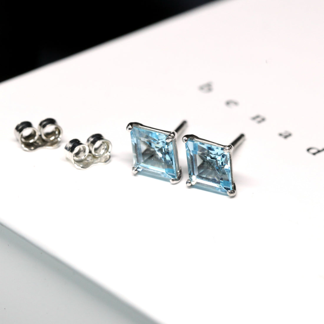 Side view of topaz gemstone sky blue topaze earrings bena jewelry montreal fine jewelry custom made in canada with silver fancy shape blue gemstone