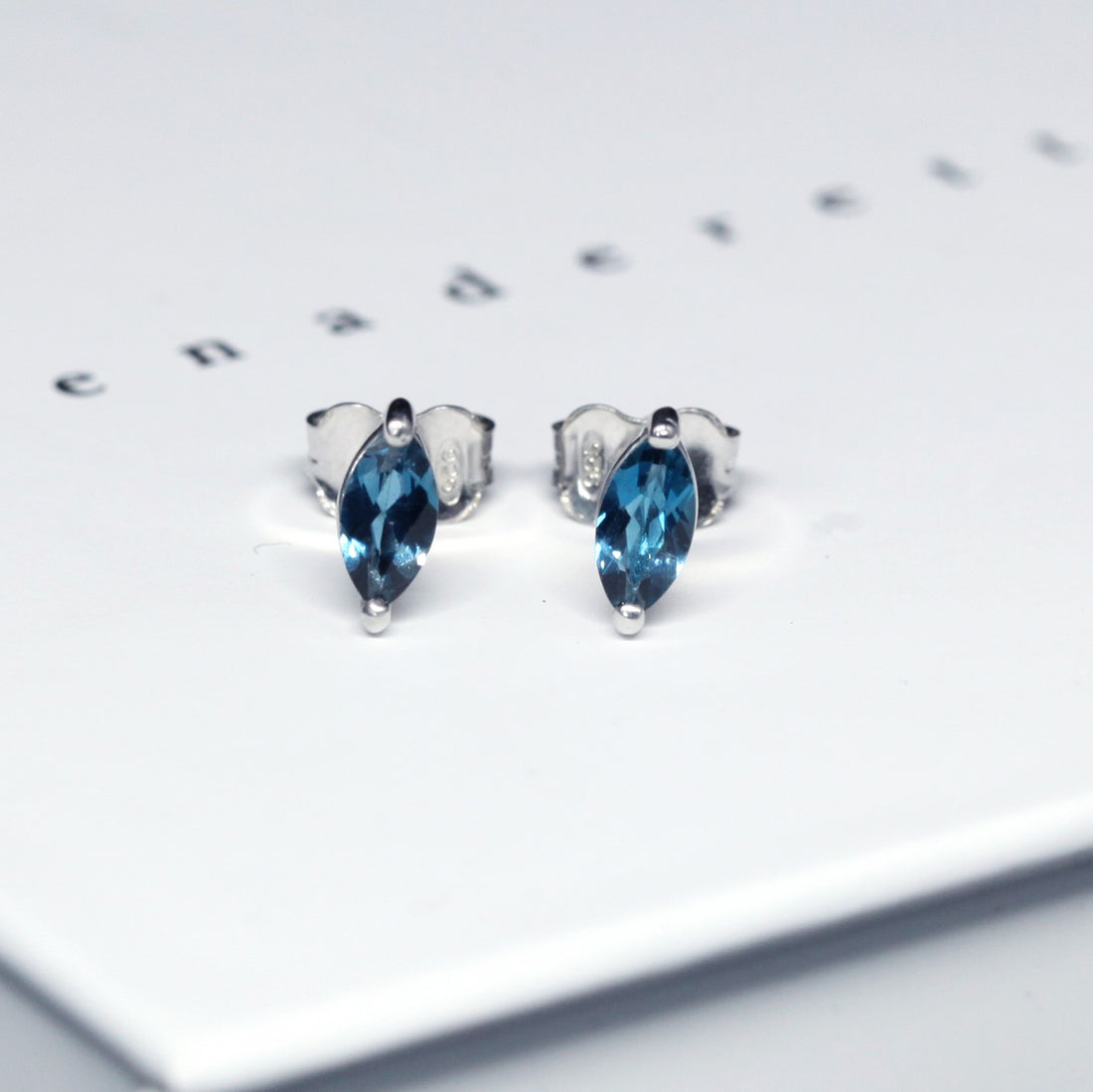 Front view of bena jewelry marquise shape london blue topaz silver earrings handmade in montreal canada custom made color gemstone jewelry specialist little italy montreal jeweler ruby mardi