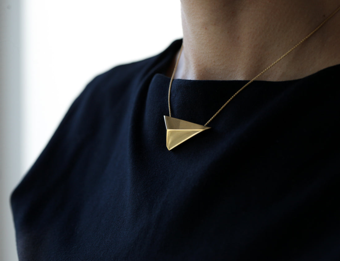 Side view of a women wearing a vermeil gold plated silver pendant made in Montreal Bena Jewelry from Edgy Collection