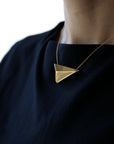 Side view of a women wearing a vermeil gold plated silver pendant made in Montreal Bena Jewelry from Edgy Collection