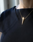 Front view of vermeil gold plated edgy pike pendant photo at natural light fine minimalist jewelry design montreal custom handmade in canada