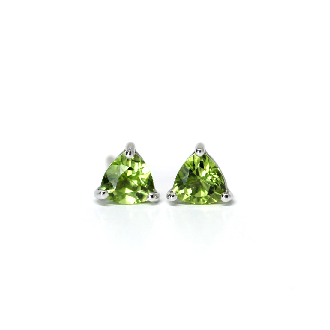 front view of peridot trillion stud earrings vivid green gemstone earrings small studs green gems custom made color gemstone jewelry montreal made in canada jewelry studio fine jewelry designer montreal