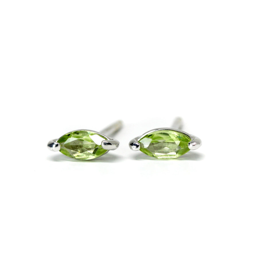 Front view of peridot stud earrings on white background small gemstone bena jewlery minimalist simple gemstone studs earrings with green gems marquise shape made in montreal canada bena jewelry fine jewelry designer