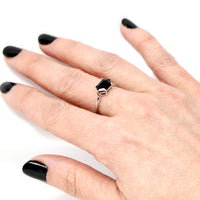 Girl wearing a hexagonal black gemstone ring custom made in montreal fine jewelry signature design edgy style custom bridal jewelry designer bena jewelry montreal made in canada simple modern color gemstone engagement ring