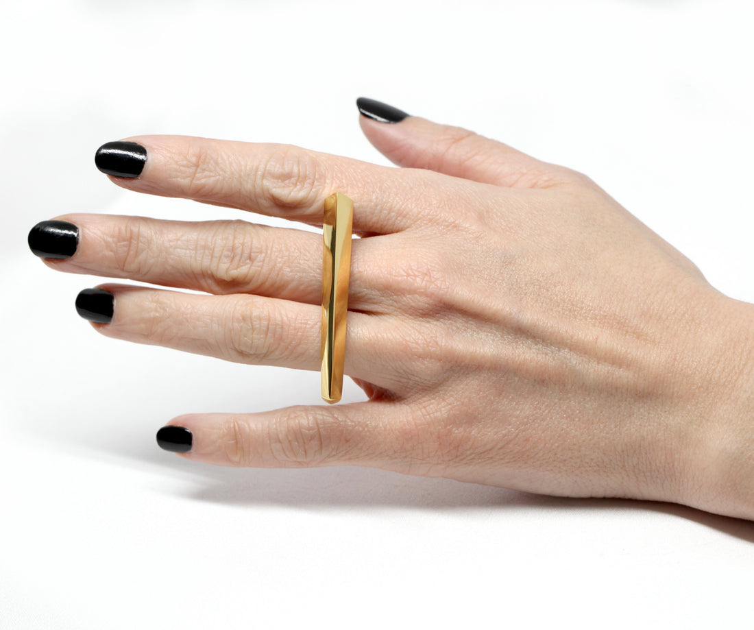 Front view of girl's hand wearing double finger vermeil gold statement Edgy Bold Ring Fine jewelry designer montreal made in canada silver yellow gold plated