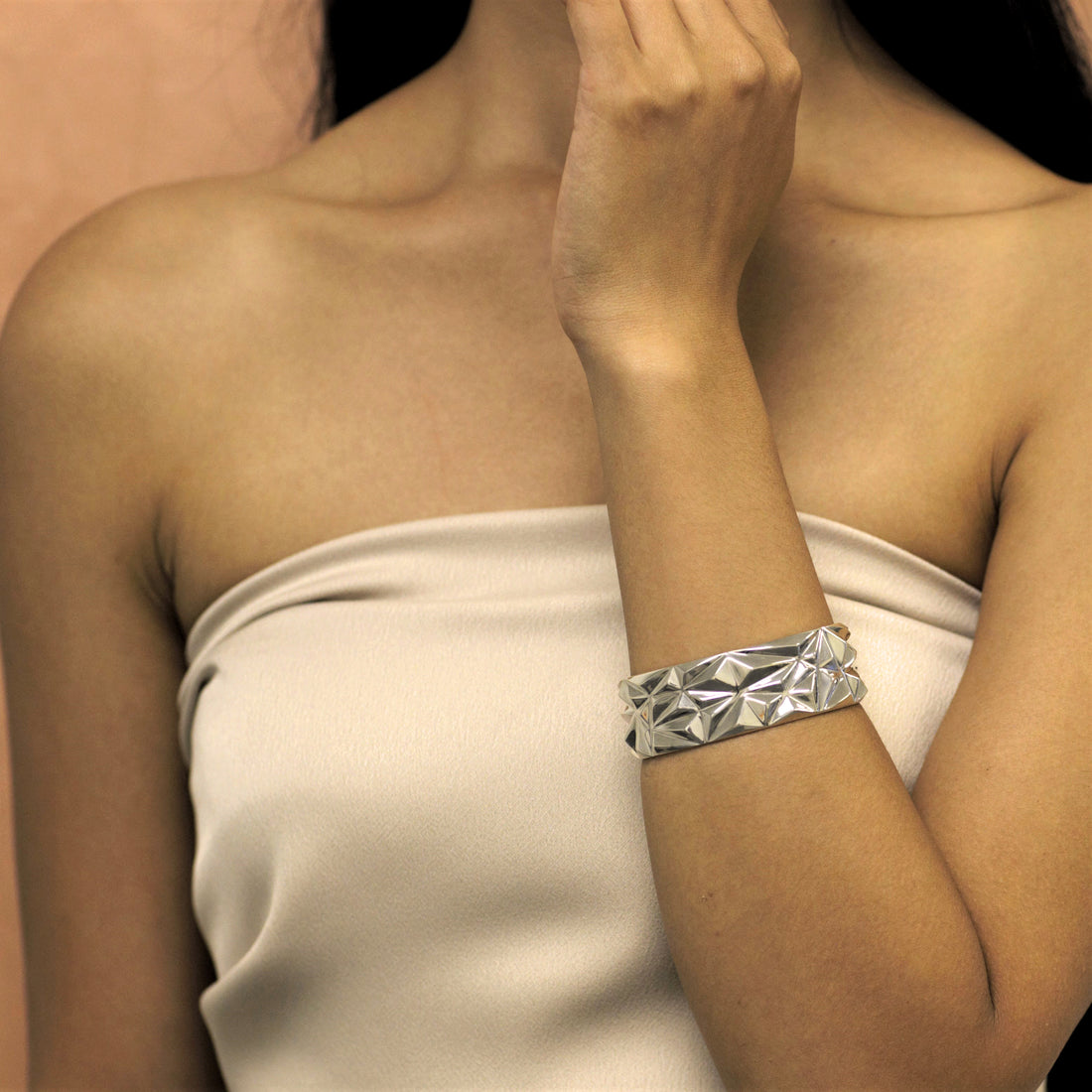 Woman wearing statement bracelet. Silver jewelry bracelet. Big silver bracelet