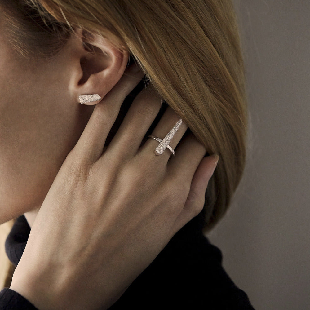 Close-up of Diamond Pike Ring on hand, emphasizing the sharp lines and contemporary aesthetics, crafted in Montreal.