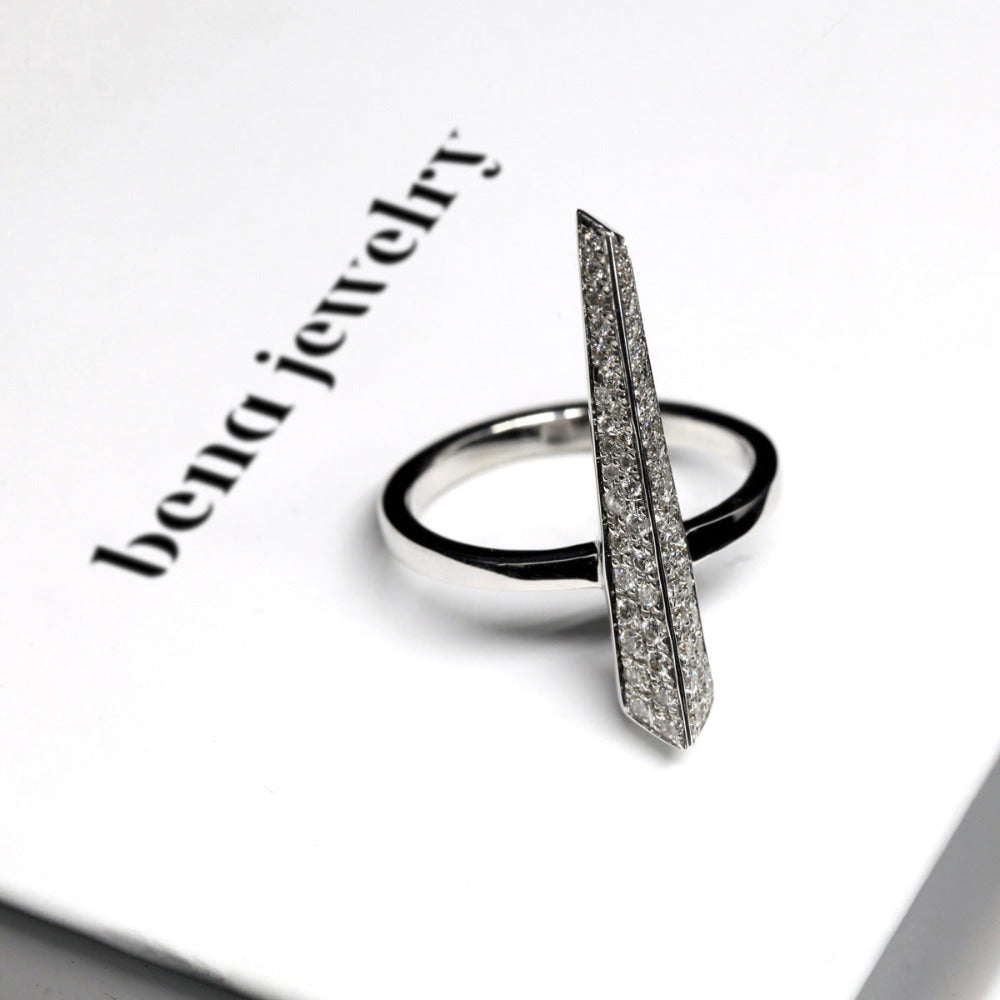 Diamond Pike Ring displayed against a golden background, highlighting the sharp white gold design and brilliance of 0.34 ct natural diamonds by a Canadian designer.