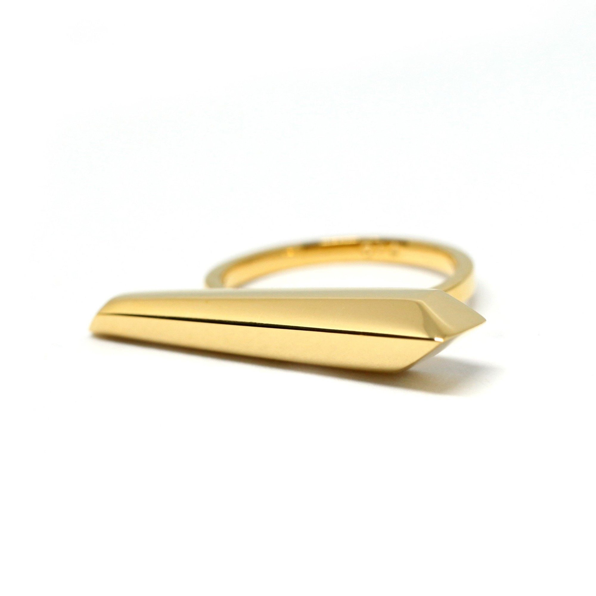 A modern and sleek ring in yellow gold seen on a white background. This jewel is an original design from independent Canadian brand Bena Jewelry.