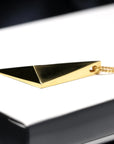 Side view of arty pendant edgy collection bena jewelry montreal custom made jewelry unisexe minimalist simple luxury pendant montreal made in canada simple shape silver yellow gold plated jewelry timeless design pyramidal shape gold jewelery
