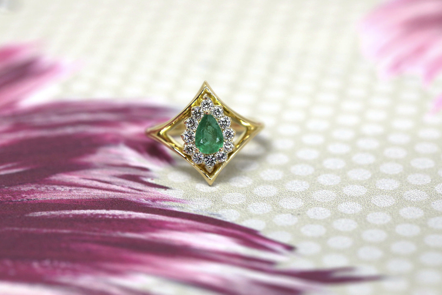 Close-up of the ring, capturing the emerald’s brilliance and the halo’s fine detailing. Crafted by Bena Jewelry in Montreal, Canada, this is a luxurious custom piece.