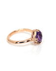 side view of rose gold statement ring with a purple gemstone amethsyt cushion cut made by bena jewelry designer montreal on a white background