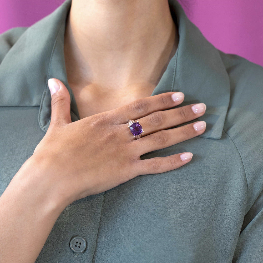 Portrait with model: A model confidently wearing the Amethyst Cocktail Ring, highlighting its bold design and the vibrant Brazilian amethyst. Designed by Bena Jewelry in Montreal, Canada, the ring stands out as a unique statement piece.