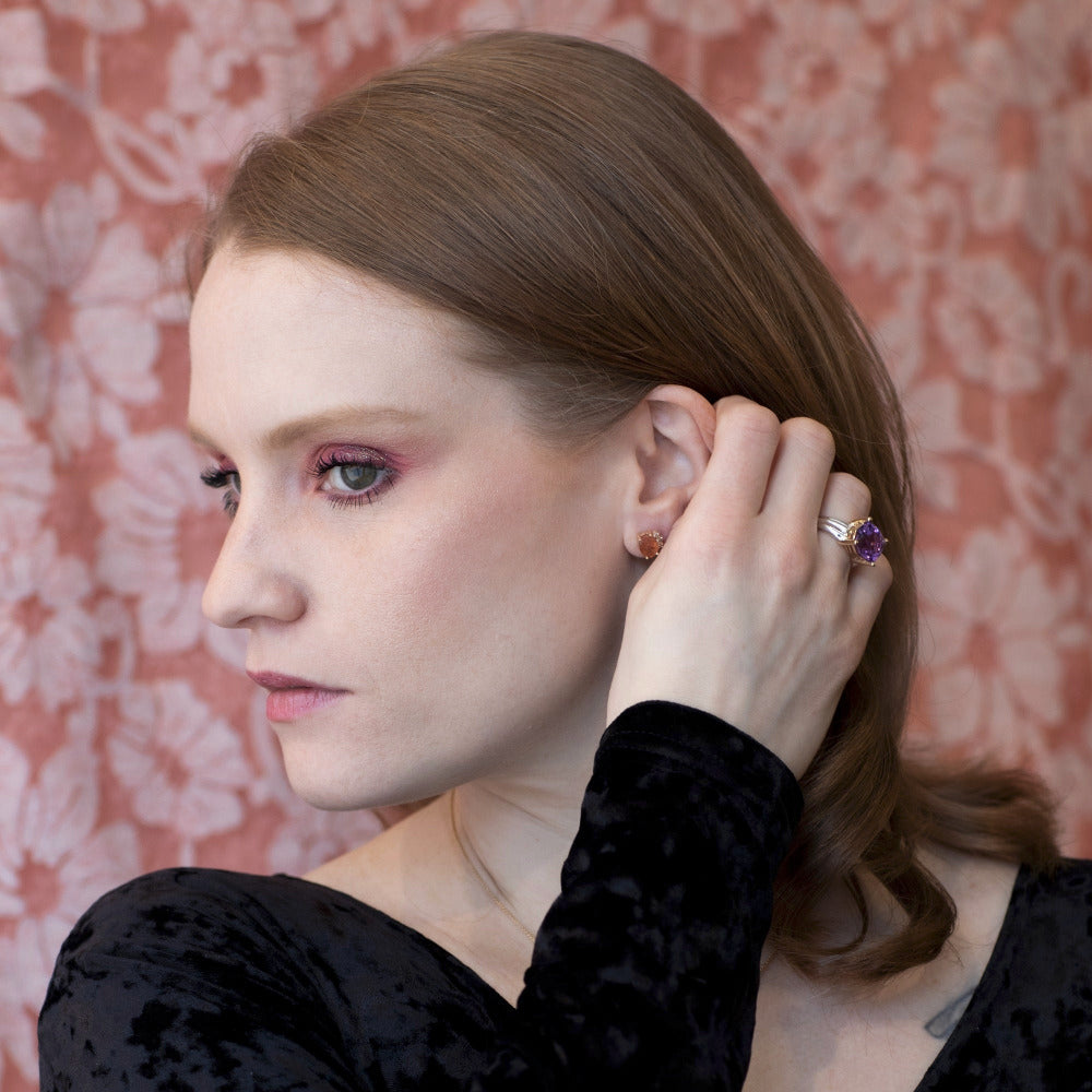 Worn by a model (portrait): A woman wearing the Amethyst Cocktail Ring, illustrating its bold presence and contemporary elegance.