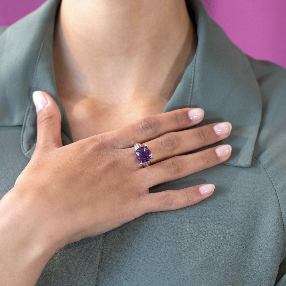 Close-up of the ring on a model’s hand: Focus on the interplay of the silver and gold band with the deep purple amethyst, showcasing the craftsmanship of Bena Jewelry, made in Montreal, Canada.
