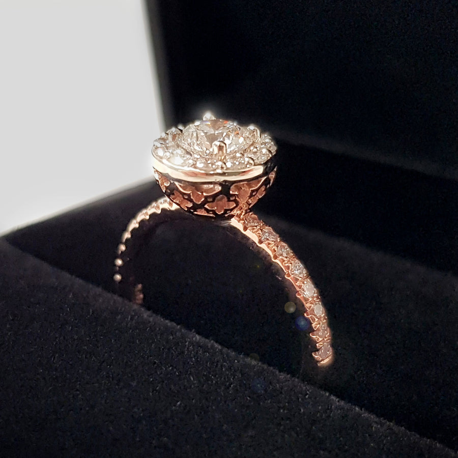 side view of rose gold diamond engagement ring montreal bena jewelry custom bridal jewelry designer handamde rose gold diamond ring small diamond halo diamond jewelry made in montreal