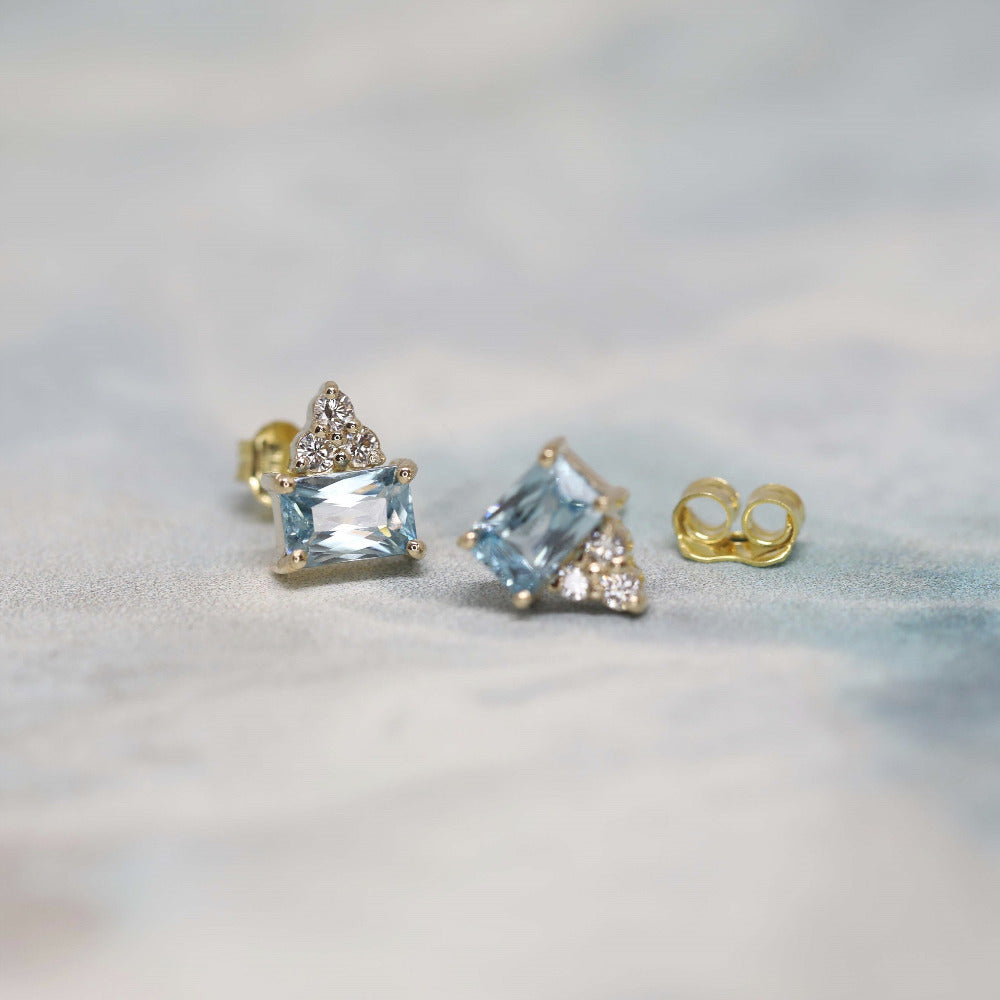 Designer-crafted earrings showcasing natural gemstones in a subtle yet striking yellow gold frame.